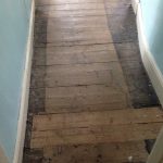 Wide floorboards change to narrow boards along passageway 01